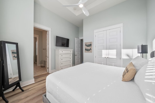 bedroom featuring ceiling fan, a closet, and light hardwood / wood-style floors