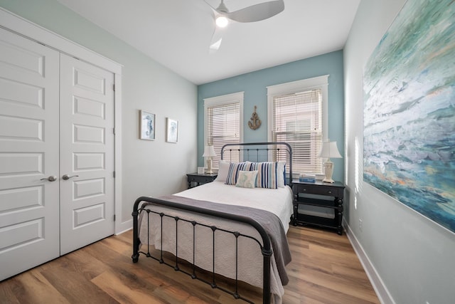 bedroom featuring hardwood / wood-style floors, ceiling fan, and a closet