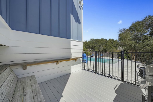 wooden deck featuring a covered pool