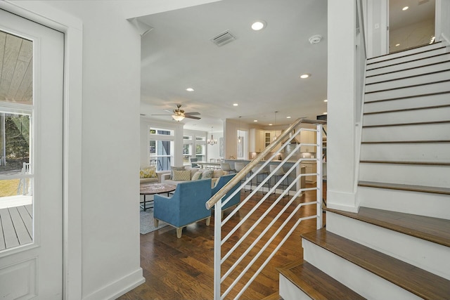 staircase featuring ceiling fan and hardwood / wood-style flooring