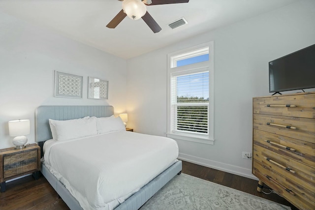 bedroom with dark hardwood / wood-style floors and ceiling fan