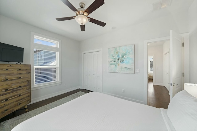 bedroom with a closet, ceiling fan, and dark wood-type flooring