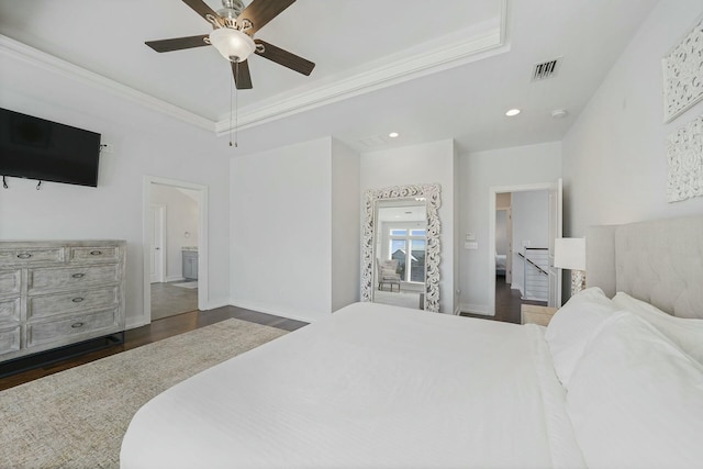 bedroom with ceiling fan, dark hardwood / wood-style floors, crown molding, and ensuite bath