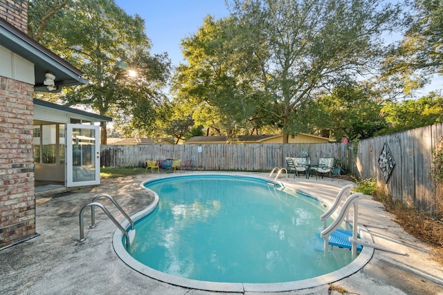 view of swimming pool with a patio area