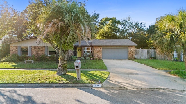 single story home featuring a garage and a front yard