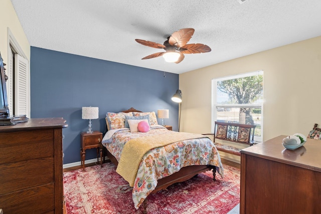 bedroom with ceiling fan, a closet, and a textured ceiling