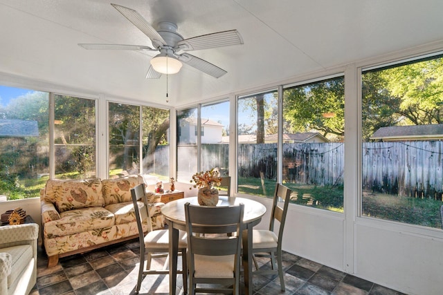 sunroom / solarium featuring ceiling fan