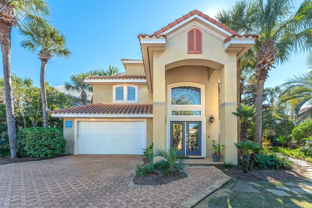 view of front of house with french doors and a garage