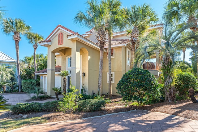 mediterranean / spanish home featuring a garage