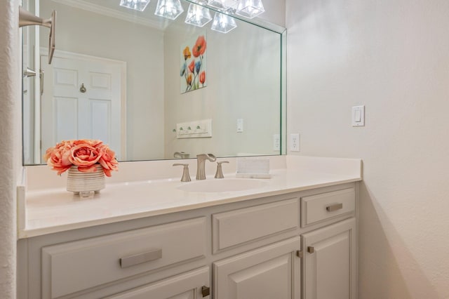 bathroom with crown molding and vanity