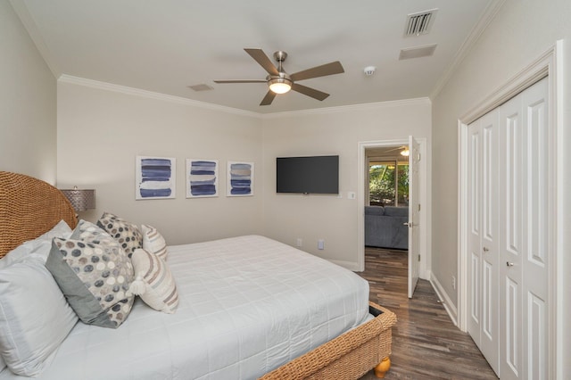 bedroom featuring dark wood-type flooring, access to outside, crown molding, ceiling fan, and a closet