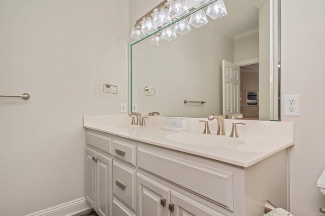 bathroom with vanity and ornamental molding