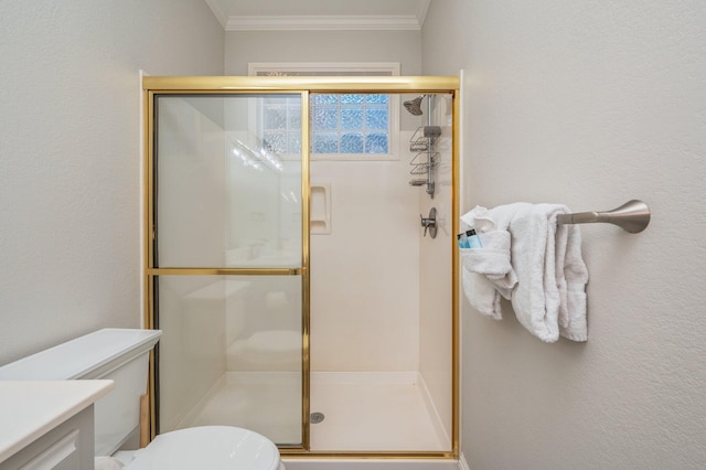 bathroom featuring ornamental molding, vanity, toilet, and a shower with shower door