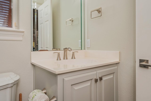 bathroom featuring vanity and toilet