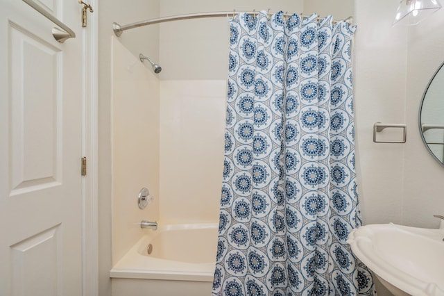 bathroom featuring shower / bath combo and sink