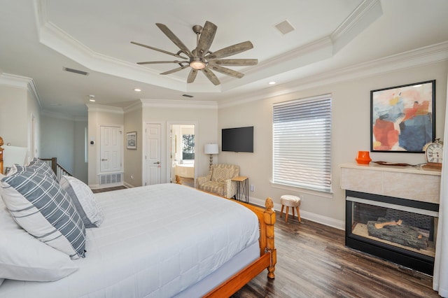 bedroom with a raised ceiling, ceiling fan, and crown molding