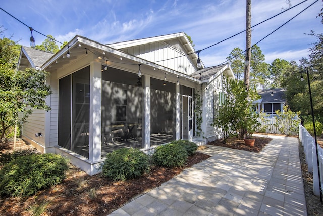 view of side of property with a sunroom