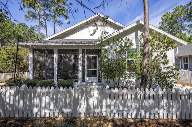 rear view of property with a sunroom