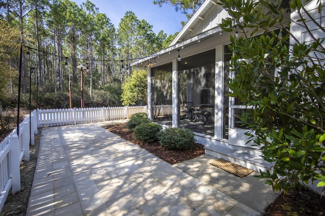 view of patio featuring a sunroom