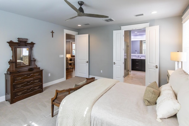 carpeted bedroom with ceiling fan and ensuite bathroom