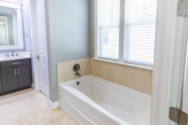 bathroom featuring vanity, tile patterned floors, and a bathtub