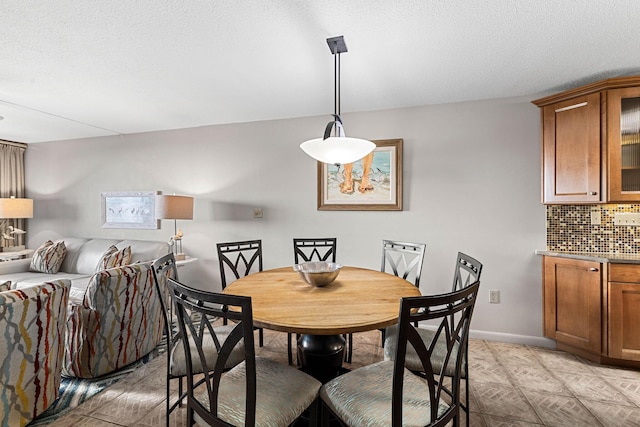 dining room featuring a textured ceiling