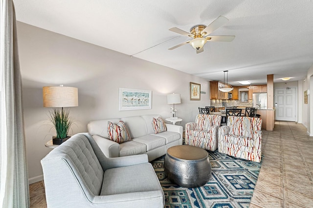 tiled living room featuring ceiling fan and a textured ceiling