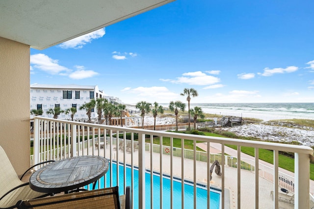 balcony with a view of the beach and a water view