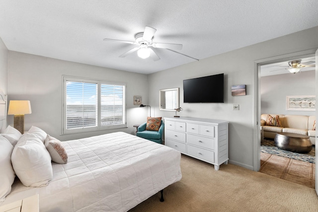 carpeted bedroom with a textured ceiling and ceiling fan