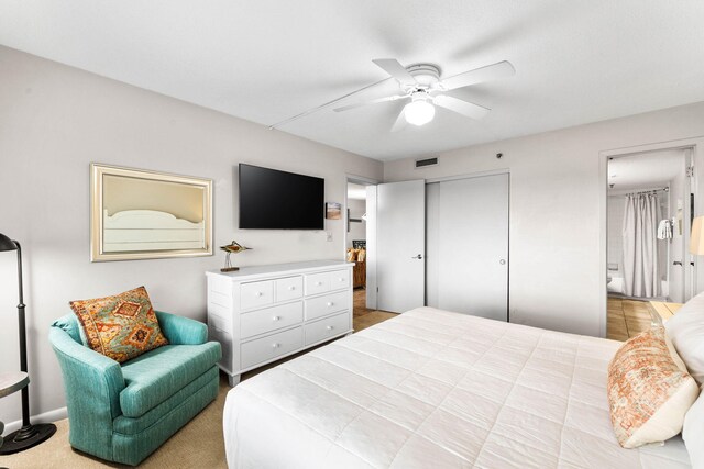 bedroom with ceiling fan and a closet