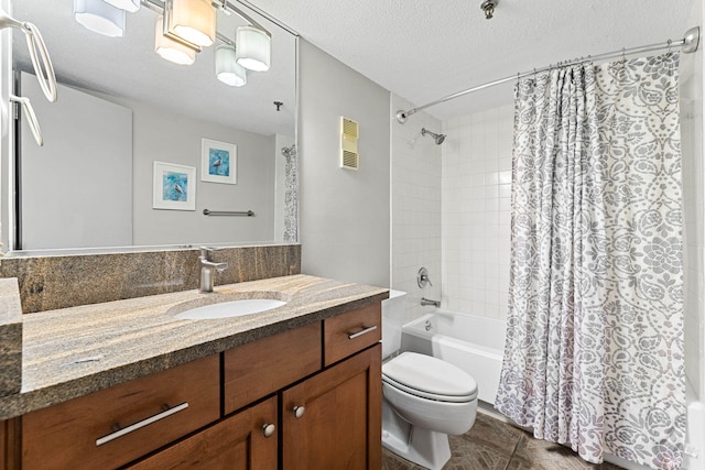 full bathroom featuring shower / bath combo, vanity, a textured ceiling, tile patterned flooring, and toilet