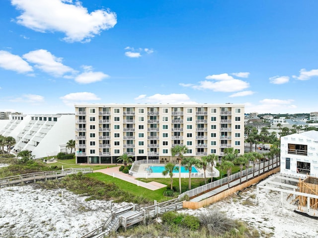 view of building exterior featuring a community pool