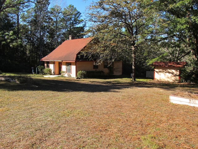 exterior space with a front yard and a shed