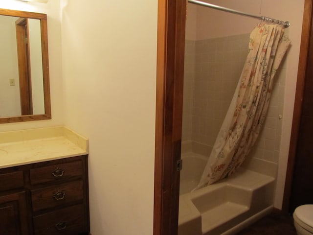 full bathroom with vanity, shower / tub combo, and toilet