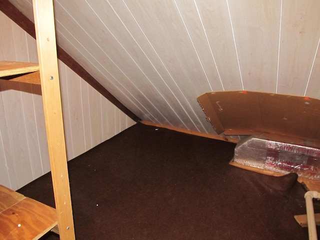 interior space featuring wood walls and lofted ceiling