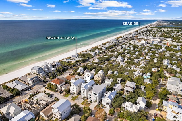 drone / aerial view featuring a water view and a view of the beach