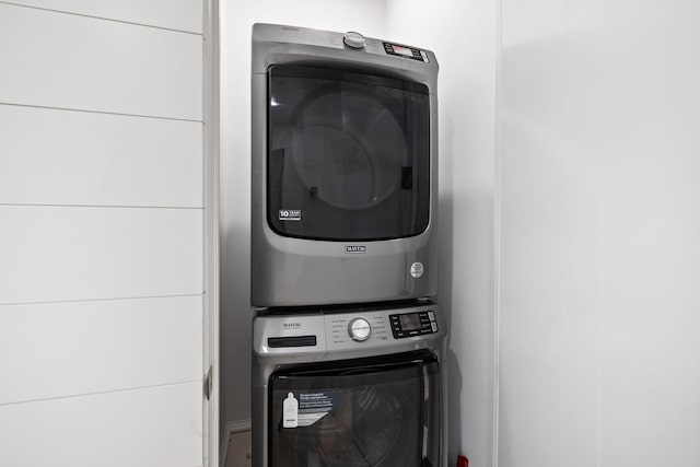 laundry area featuring stacked washer / dryer