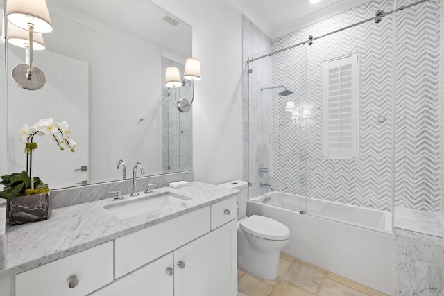 full bathroom featuring vanity, toilet, crown molding, and tiled shower / bath