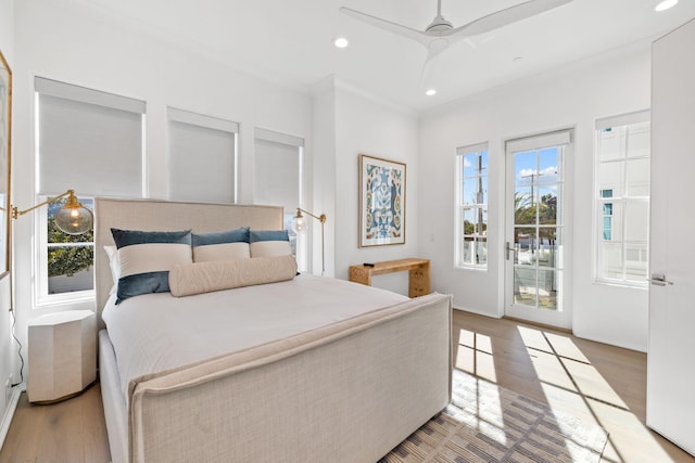 bedroom with access to exterior, hardwood / wood-style flooring, multiple windows, and ceiling fan