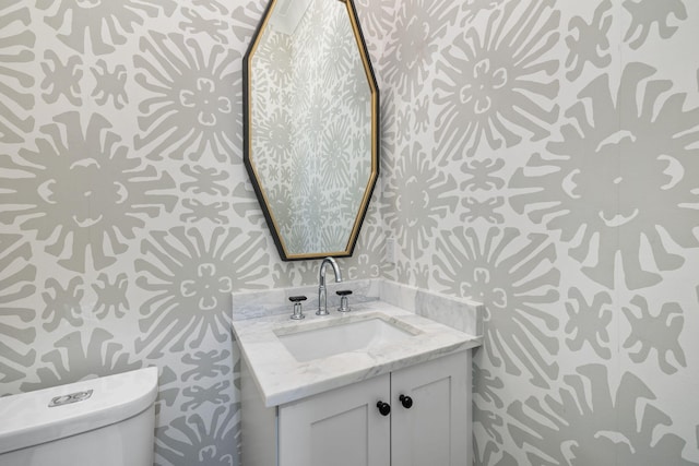 bathroom featuring vanity and toilet