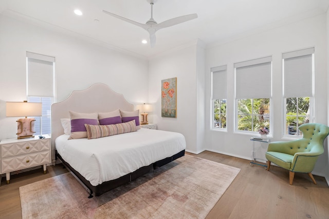 bedroom with ceiling fan, ornamental molding, and hardwood / wood-style flooring