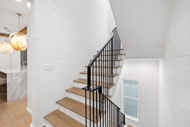 staircase with hardwood / wood-style flooring