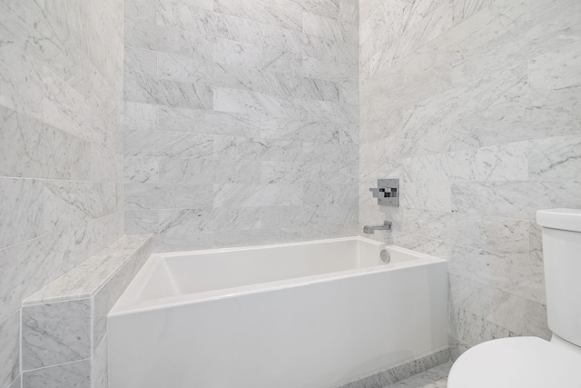 bathroom with a washtub and toilet