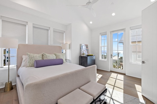 bedroom featuring access to exterior, hardwood / wood-style flooring, vaulted ceiling, and ceiling fan