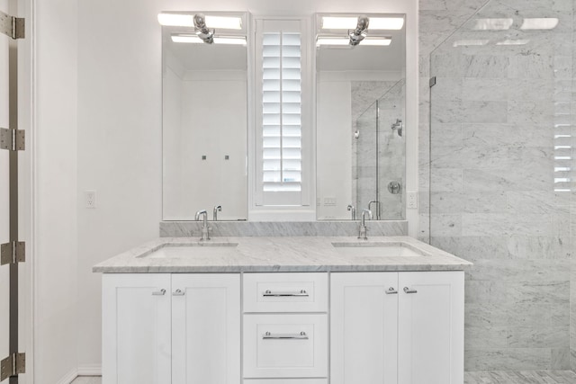 bathroom with a shower with door and vanity