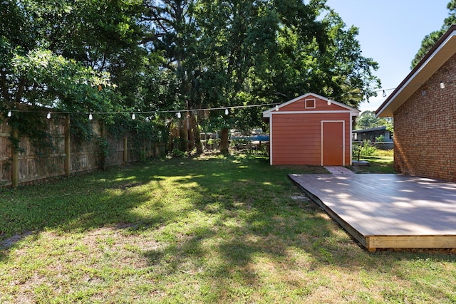 view of yard featuring a deck and a storage shed