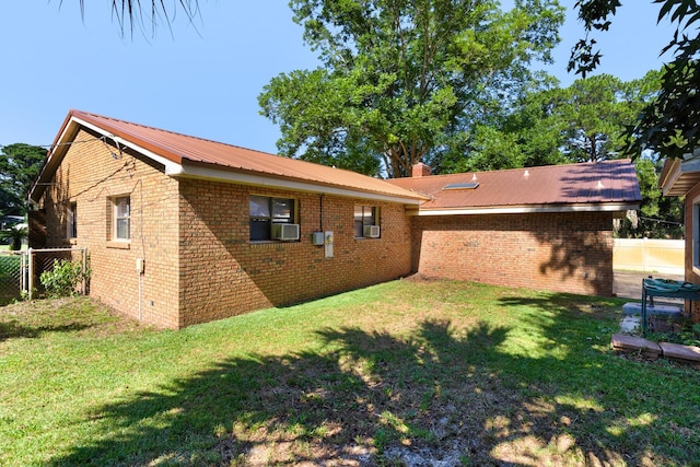 back of property with cooling unit and a lawn