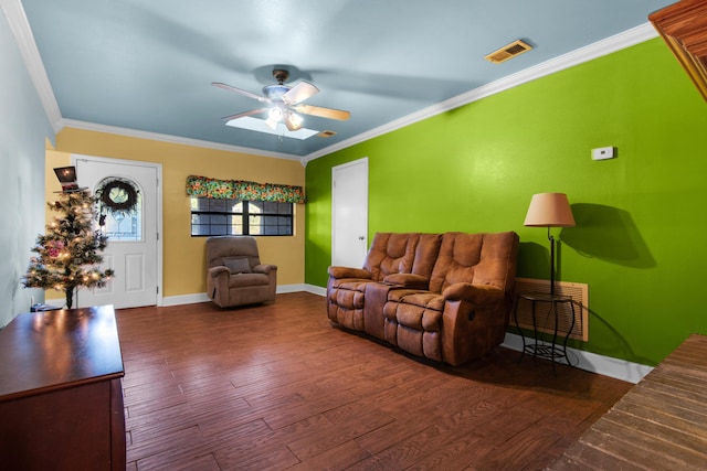 living room with ornamental molding, ceiling fan, and dark wood-type flooring