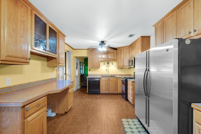 kitchen featuring ceiling fan, sink, light wood-type flooring, black appliances, and ornamental molding