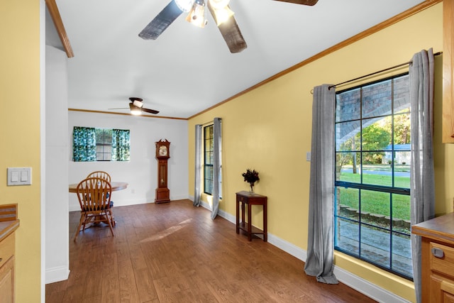 entryway featuring ornamental molding, a wealth of natural light, dark wood-type flooring, and ceiling fan